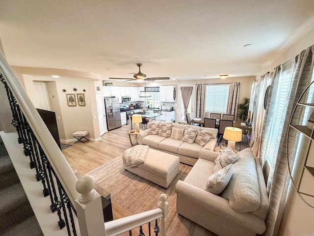 1410 Franceschi Dr, Chula Vista, CA 91913 - living area featuring light wood-type flooring, ceiling fan, and stairs