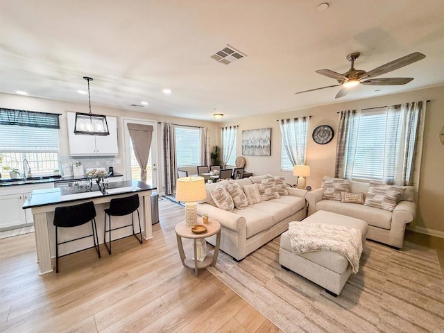 1410 Franceschi Dr, Chula Vista, CA 91913 - living room featuring light wood finished floors, recessed lighting, healthy amount of natural light, and ceiling fan