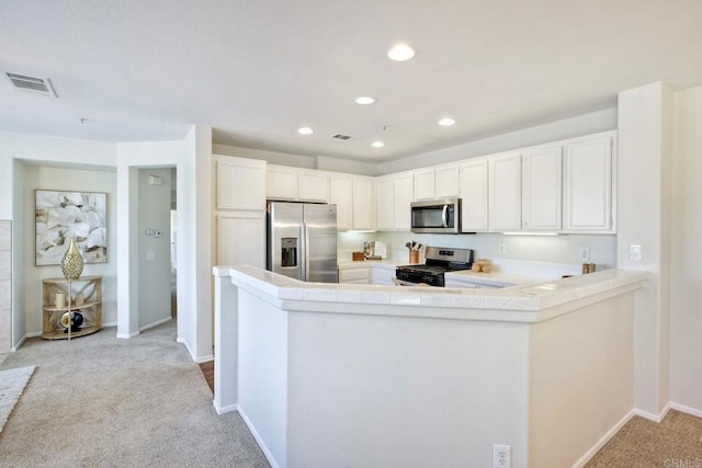 33657 Emerson Way Unit C, Temecula, CA 92592 - kitchen with stainless steel appliances, light colored carpet, a peninsula, light countertops, and recessed lighting