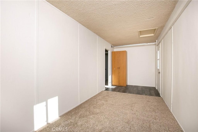 46404 Kings Canyon Rd, Lancaster, CA 93536 - hall featuring attic access, a textured ceiling, and dark colored carpet