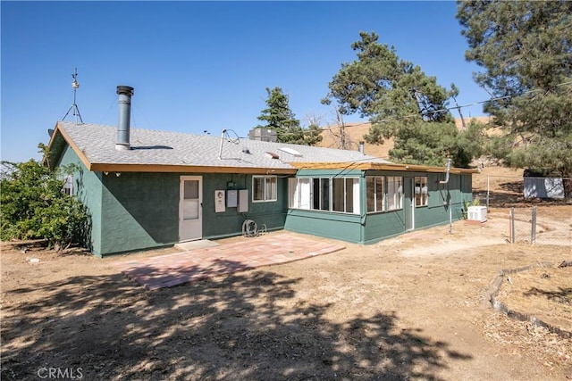 46404 Kings Canyon Rd, Lancaster, CA 93536 - back of property with a sunroom, a patio, stucco siding, and roof with shingles