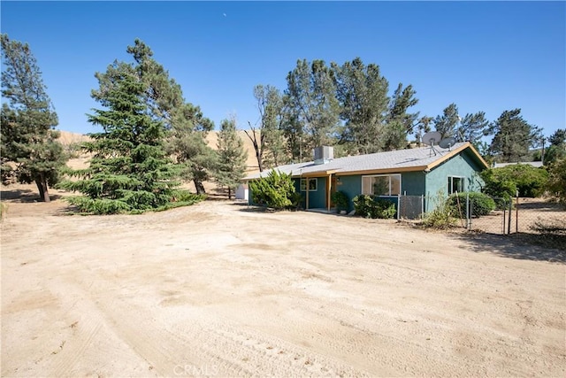 46404 Kings Canyon Rd, Lancaster, CA 93536 - view of front of home featuring stucco siding and a chimney