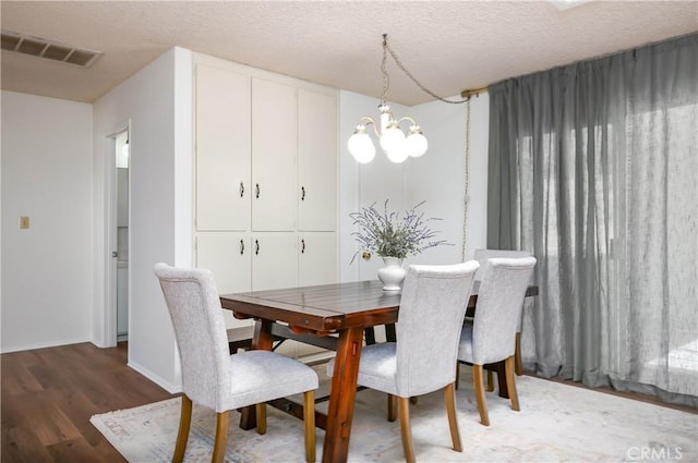 46404 Kings Canyon Rd, Lancaster, CA 93536 - dining space featuring wood finished floors, a chandelier, and a textured ceiling