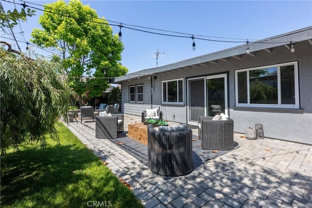 2054 Pattiz Ave, Long Beach, CA 90815 - back of property featuring outdoor lounge area, a patio area, and stucco siding