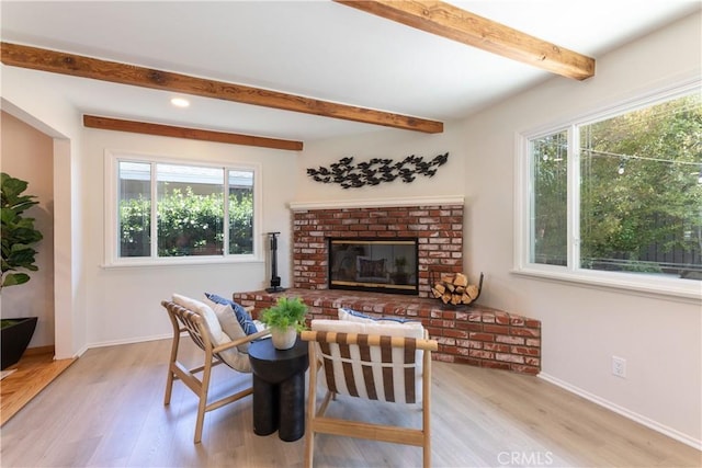 2054 Pattiz Ave, Long Beach, CA 90815 - living area with light wood finished floors, beam ceiling, healthy amount of natural light, a brick fireplace, and recessed lighting