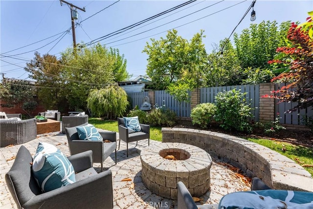 2054 Pattiz Ave, Long Beach, CA 90815 - fenced backyard featuring an outdoor living space with a fire pit and a patio area