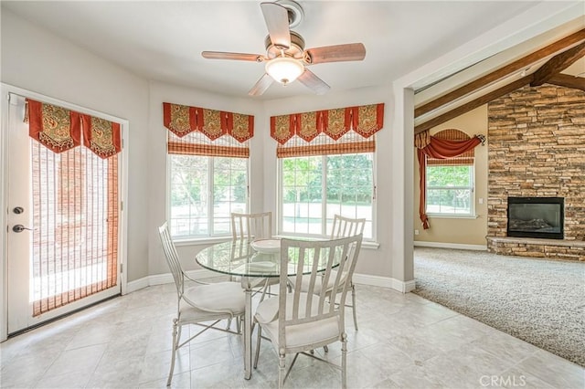 2457 Remington Ct, Merced, CA 95340 - dining area featuring light tile patterned floors, ceiling fan, light colored carpet, and a fireplace