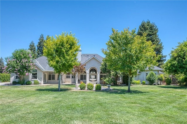 2457 Remington Ct, Merced, CA 95340 - obstructed view of property featuring a front lawn and stucco siding