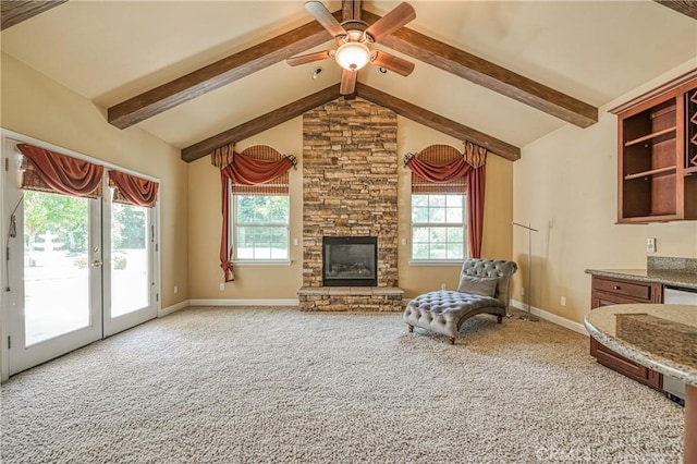 2457 Remington Ct, Merced, CA 95340 - unfurnished living room with carpet flooring, plenty of natural light, a ceiling fan, and a stone fireplace