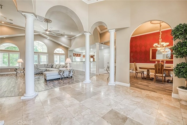 2457 Remington Ct, Merced, CA 95340 - living area featuring ornate columns, a ceiling fan, crown molding, an accent wall, and vaulted ceiling