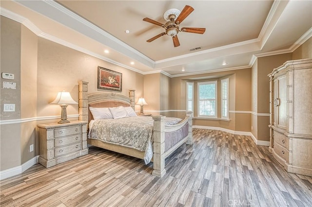 2457 Remington Ct, Merced, CA 95340 - bedroom with light wood finished floors, a tray ceiling, ceiling fan, and recessed lighting