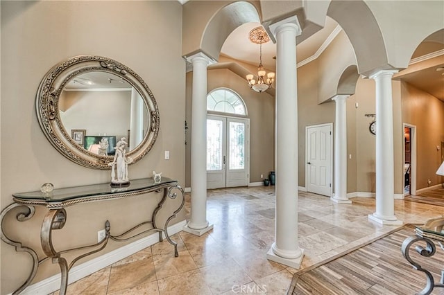 2457 Remington Ct, Merced, CA 95340 - foyer featuring ornate columns, ornamental molding, a towering ceiling, french doors, and light marble finish floors