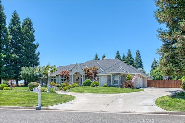2457 Remington Ct, Merced, CA 95340 - ranch-style home featuring driveway, stone siding, and a garage