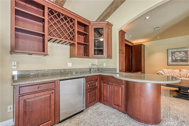 2457 Remington Ct, Merced, CA 95340 - kitchen with open shelves, arched walkways, open floor plan, a peninsula, and fridge