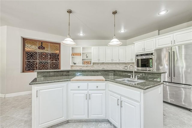 2457 Remington Ct, Merced, CA 95340 - kitchen featuring stainless steel appliances, white cabinetry, pendant lighting, dark stone counters, and recessed lighting