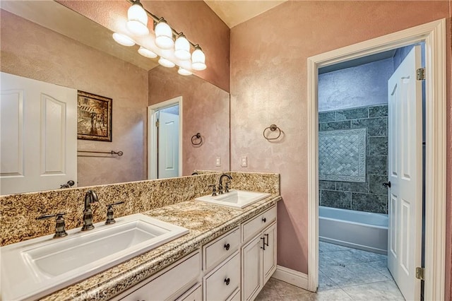 2457 Remington Ct, Merced, CA 95340 - full bath featuring double vanity, tile patterned flooring, and a textured wall