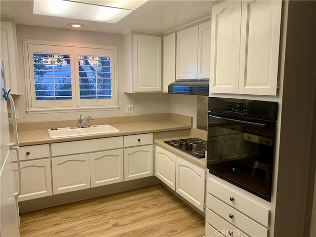 930 Avenida Majorca Unit A, Laguna Woods, CA 92637 - kitchen featuring black appliances, white cabinets, light wood-type flooring, exhaust hood, and recessed lighting
