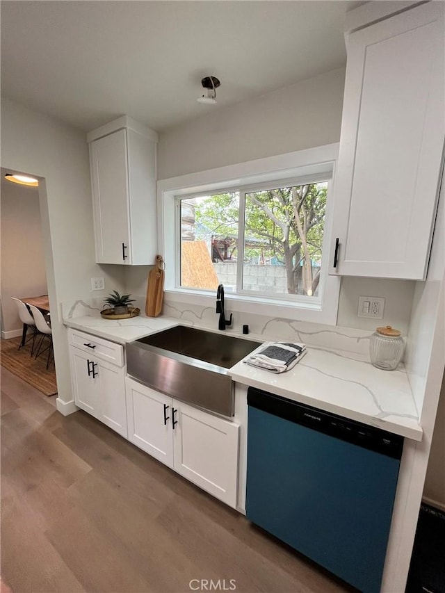 13723 Pinney St, Pacoima, CA 91331 - kitchen featuring dishwashing machine, light stone counters, wood finished floors, and white cabinetry