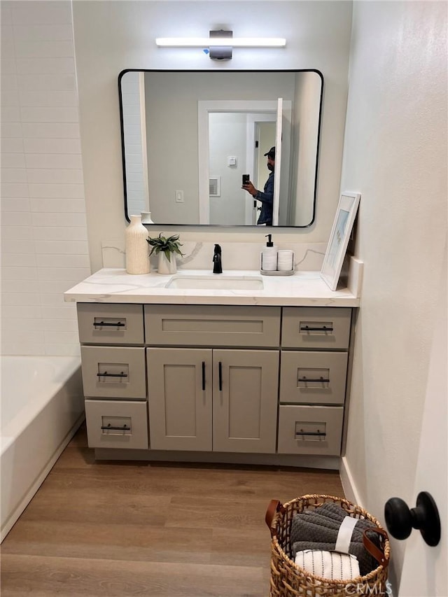 13723 Pinney St, Pacoima, CA 91331 - full bathroom with vanity and wood finished floors
