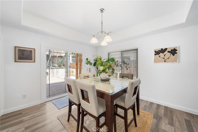 2981 Pembroke Cir, Corona, CA 92879 - dining room with a tray ceiling, a chandelier, and wood finished floors