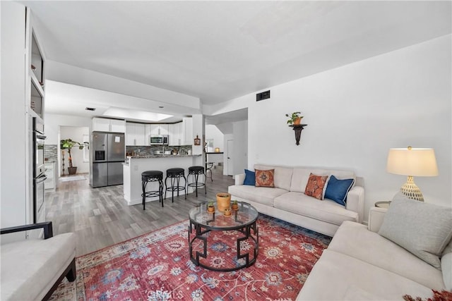 2981 Pembroke Cir, Corona, CA 92879 - living area featuring light wood-style floors and baseboards