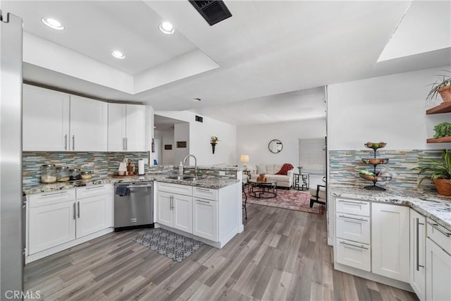 2981 Pembroke Cir, Corona, CA 92879 - kitchen featuring dishwasher, a peninsula, open floor plan, white cabinetry, and recessed lighting