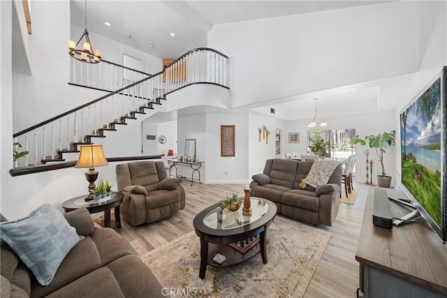 2981 Pembroke Cir, Corona, CA 92879 - living area with a chandelier, stairway, light wood-style flooring, recessed lighting, and a towering ceiling