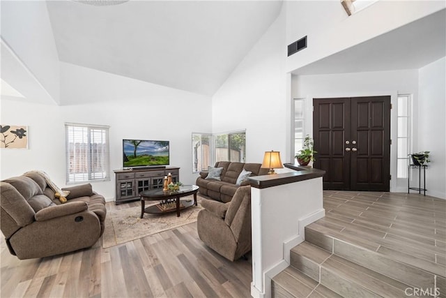2981 Pembroke Cir, Corona, CA 92879 - living area featuring high vaulted ceiling and light wood-style flooring