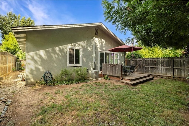 401 W 6th Ave, Chico, CA 95926 - back of house with a fenced backyard, a deck, and stucco siding