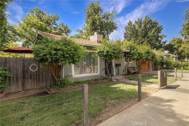 401 W 6th Ave, Chico, CA 95926 - view of property hidden behind natural elements featuring a fenced front yard, a chimney, and stucco siding