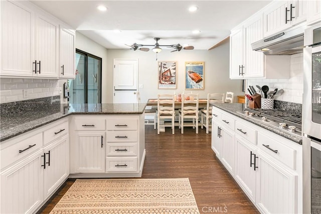 248 Hemlock Dr, Lake Arrowhead, CA 92352 - kitchen with a peninsula, white cabinets, dark wood finished floors, decorative backsplash, and recessed lighting