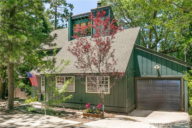 248 Hemlock Dr, Lake Arrowhead, CA 92352 - view of front of home with roof with shingles, a chimney, board and batten siding, driveway, and an attached garage
