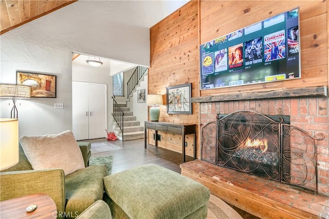 248 Hemlock Dr, Lake Arrowhead, CA 92352 - living room featuring stairs, wood finished floors, a fireplace, and wooden walls