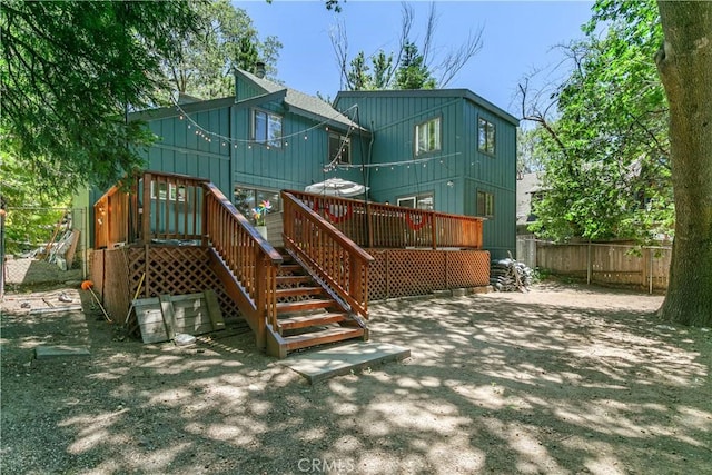 248 Hemlock Dr, Lake Arrowhead, CA 92352 - back of property with board and batten siding, a wooden deck, and stairway