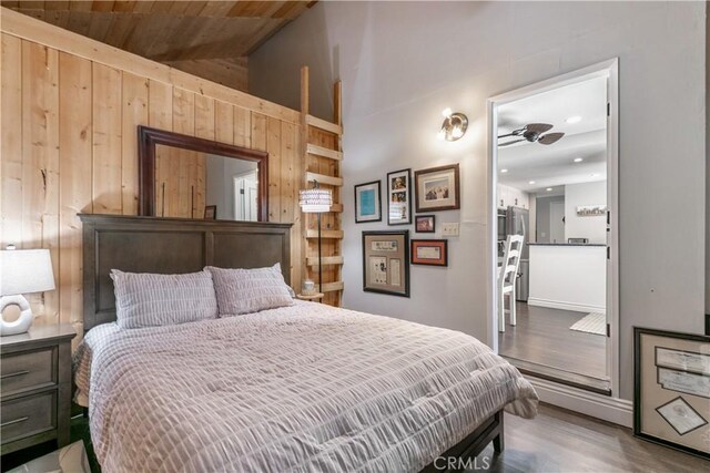 248 Hemlock Dr, Lake Arrowhead, CA 92352 - bedroom with wood walls, wood finished floors, and vaulted ceiling