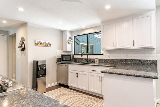 248 Hemlock Dr, Lake Arrowhead, CA 92352 - kitchen featuring stainless steel appliances, white cabinets, backsplash, dark wood-style flooring, and recessed lighting