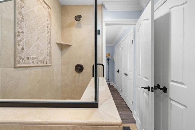 804 N The Strand Unit 11, Oceanside, CA 92054 - full bathroom featuring crown molding, wood finished floors, and a stall shower