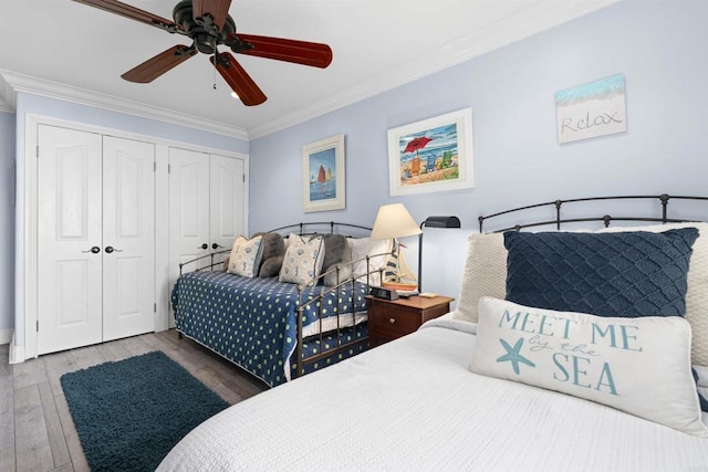 804 N The Strand Unit 11, Oceanside, CA 92054 - bedroom with multiple closets, crown molding, wood finished floors, and ceiling fan