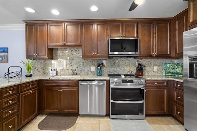 804 N The Strand Unit 11, Oceanside, CA 92054 - kitchen featuring appliances with stainless steel finishes, decorative backsplash, light stone counters, a ceiling fan, and recessed lighting