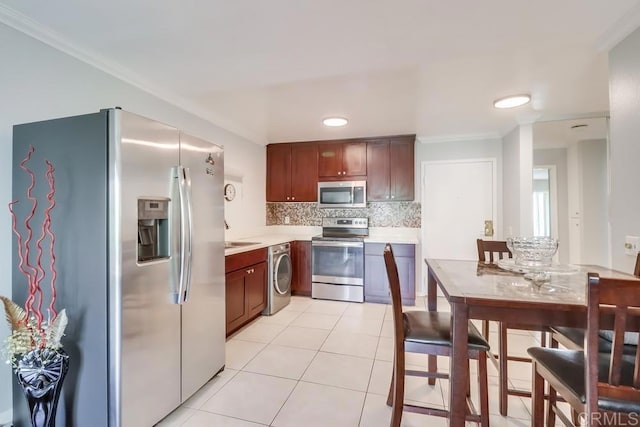 8036 Linda Vista Rd Unit 1F, San Diego, CA 92111 - kitchen featuring appliances with stainless steel finishes, light countertops, backsplash, light tile patterned floors, and crown molding