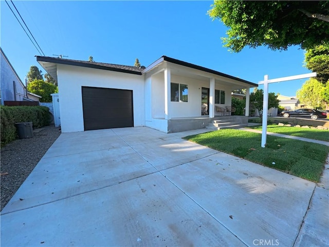 6109 E Peabody St, Long Beach, CA 90808 - view of front of house with covered porch, an attached garage, stucco siding, concrete driveway, and a front lawn