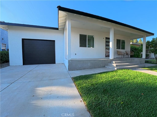 6109 E Peabody St, Long Beach, CA 90808 - view of front of house with covered porch, an attached garage, concrete driveway, and stucco siding