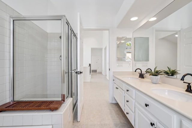 4926 Colusa Dr, Oceanside, CA 92056 - full bathroom featuring double vanity, a stall shower, tile patterned flooring, and recessed lighting