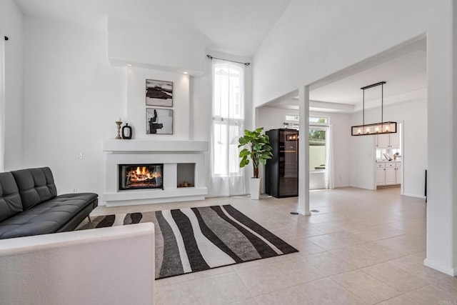 4926 Colusa Dr, Oceanside, CA 92056 - living room featuring light tile patterned flooring, plenty of natural light, a glass covered fireplace, and a chandelier