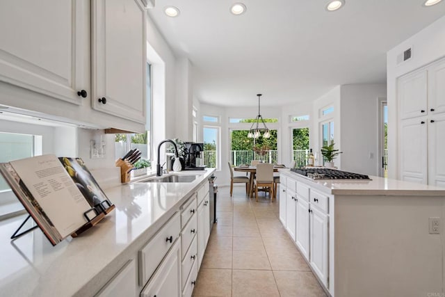 4926 Colusa Dr, Oceanside, CA 92056 - kitchen featuring recessed lighting, light countertops, white cabinets, stainless steel gas stovetop, and a kitchen island