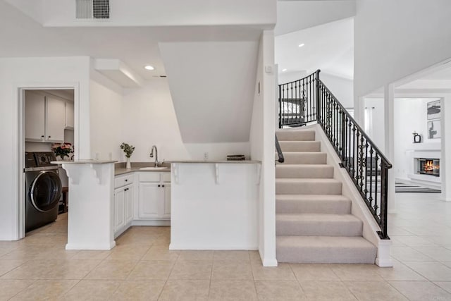 4926 Colusa Dr, Oceanside, CA 92056 - stairway with washer / clothes dryer, tile patterned flooring, recessed lighting, and a glass covered fireplace