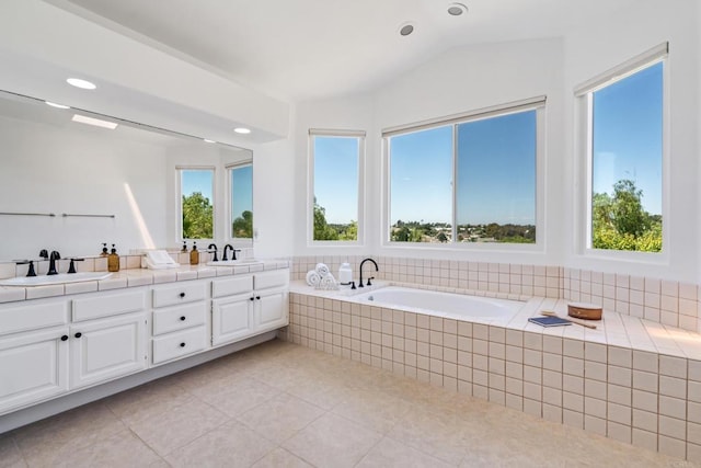 4926 Colusa Dr, Oceanside, CA 92056 - full bathroom with double vanity, healthy amount of natural light, tile patterned floors, a garden tub, and vaulted ceiling