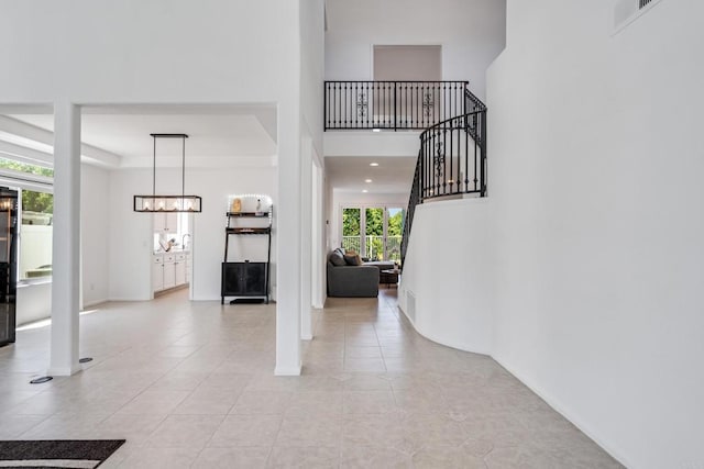 4926 Colusa Dr, Oceanside, CA 92056 - entrance foyer with light tile patterned flooring, a chandelier, and stairway