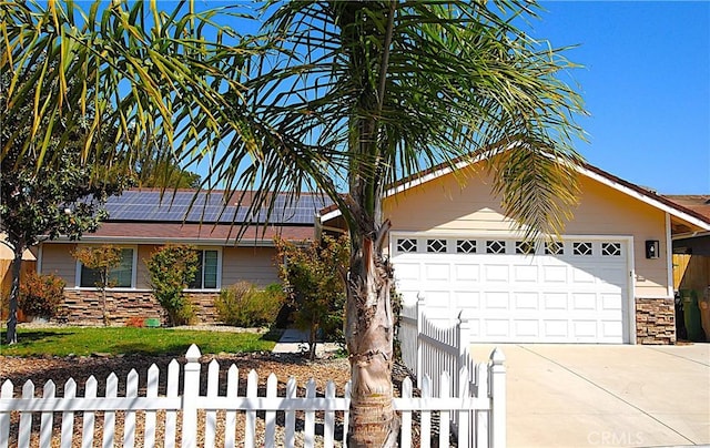 448 Grove Ln, Nipomo, CA 93444 - single story home with driveway, a fenced front yard, stone siding, solar panels, and an attached garage
