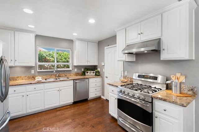 448 Grove Ln, Nipomo, CA 93444 - kitchen with appliances with stainless steel finishes, under cabinet range hood, white cabinets, dark wood finished floors, and light stone countertops